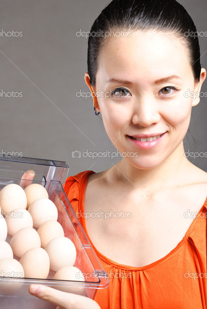 Smiling happy woman holds a basket with easter eggs