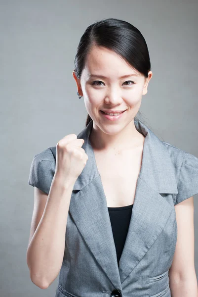 Happy Asian woman with her arms in the air cheering — Stock Photo, Image