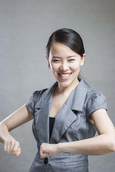 Happy Asian woman with her arms in the air cheering — Stock Photo, Image