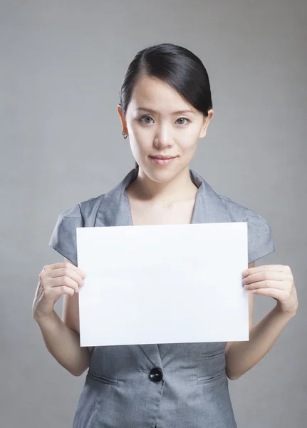 Beautiful business woman with a white banner. — Stock Photo, Image