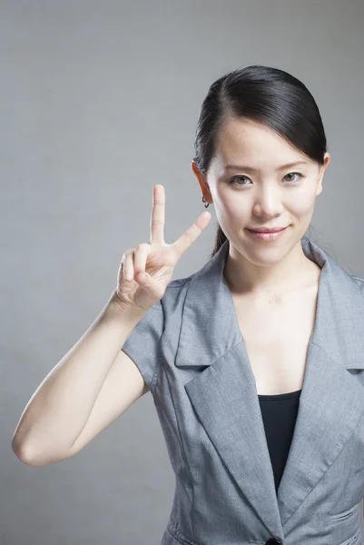 Happy Asian woman with her arms in the air cheering — Stock Photo, Image