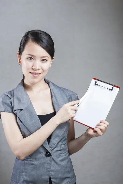 Beautiful business woman with a white banner. — Stock Photo, Image