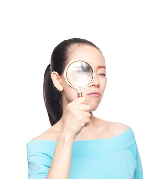 Portrait of lovely young woman with magnifying glass showing her — Stock Photo, Image