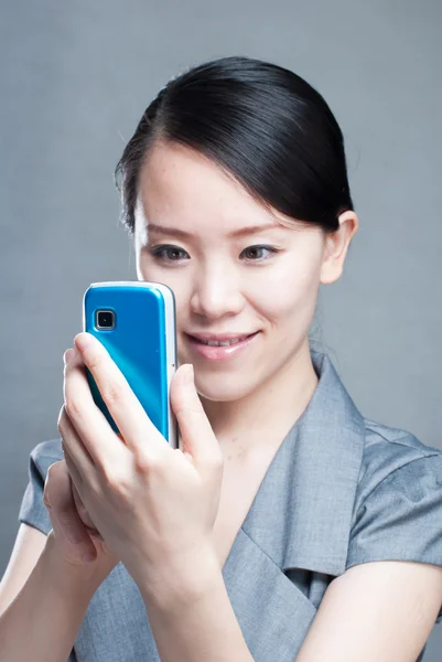 Attractive businesswoman using mobile phone — Stock Photo, Image