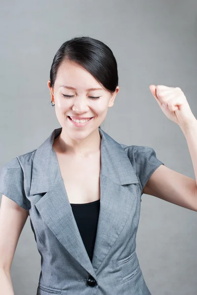 Happy Asian woman with her arms in the air cheering — Stock Photo, Image