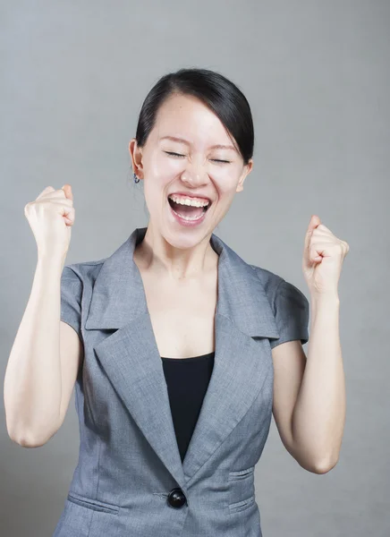 Happy Asian woman with her arms in the air cheering — Stock Photo, Image