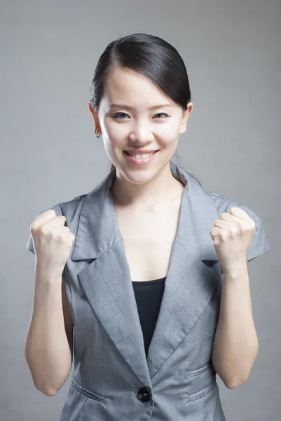 Happy Asian woman with her arms in the air cheering — Stock Photo, Image