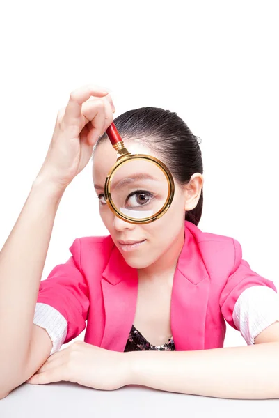 Portrait of lovely young woman with magnifying glass showing her Stock Photo