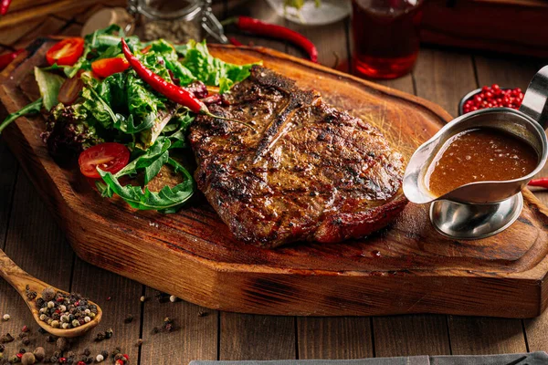 Grilled beef ribeye steak with pepper sauce — Stock Photo, Image