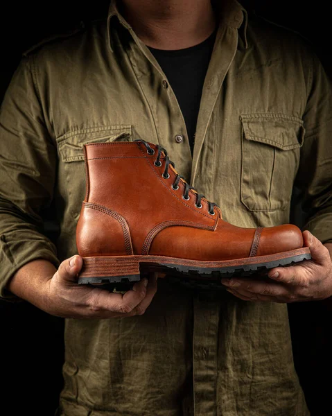 Cobbler tenant une paire de chaussures en cuir marron — Photo