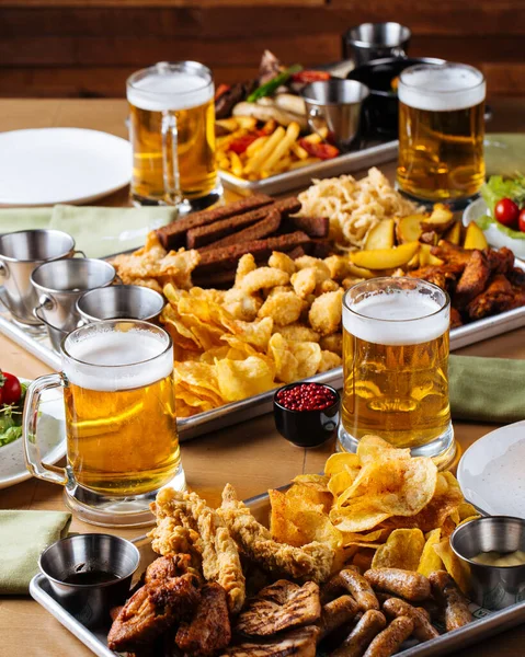 Table set with beer and salty snacks — Stock Photo, Image
