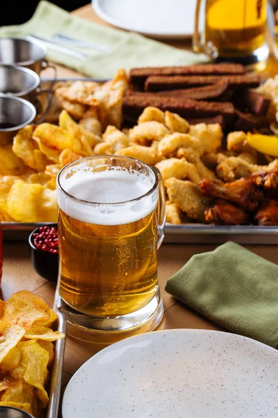 Table set with beer and salty snacks — Stock Photo, Image