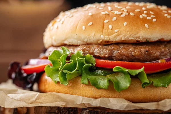 Fresh appetizing burger on wooden background — Stock Photo, Image