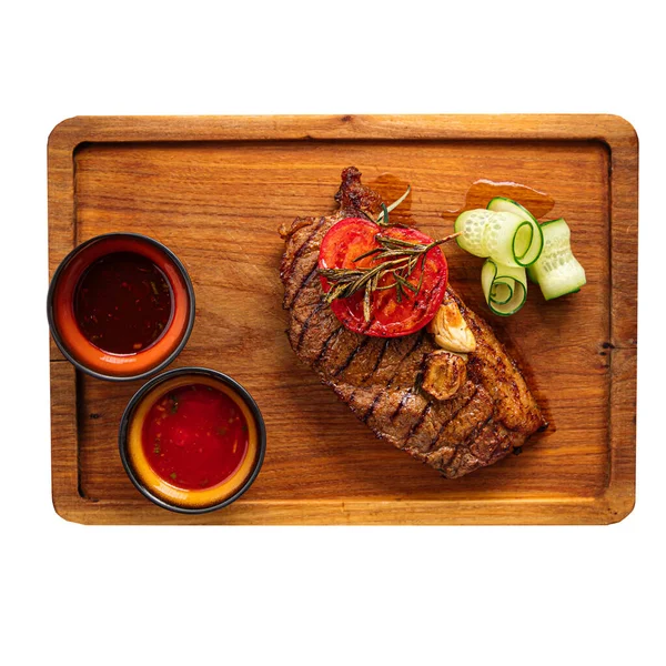 Isolated portion of grilled beef steak with sauce — Stock Photo, Image
