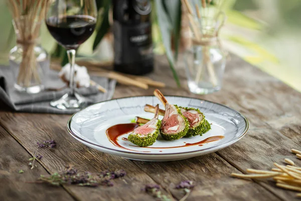 Top view on plate of gourmet lamb cutlet ribs with sauce