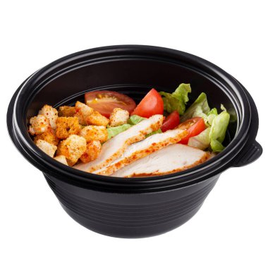 Isolated black plastic package of take away caesar salad