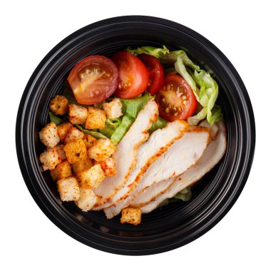Isolated black plastic package of take away caesar salad