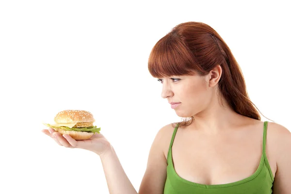 Młoda atrakcyjna kobieta jedzenie hamburgerów Obrazek Stockowy