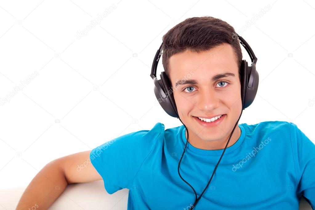 Beautiful young man listening to music on his headphones
