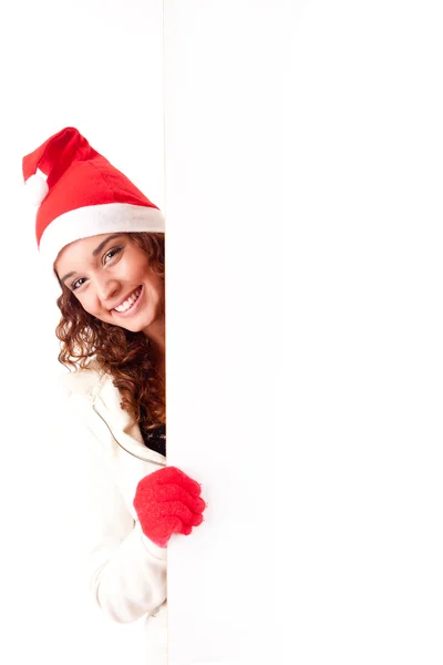 Прекрасная рождественская женщина, опирающаяся на чистый знак — стоковое фото