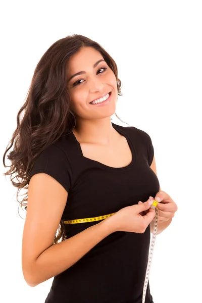 Mulher fina bonita medindo seu corpo com uma fita métrica — Fotografia de Stock