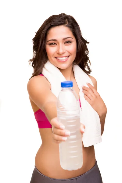 Attractive fitness woman posing with gym towel holding a bottle — Stock Photo, Image