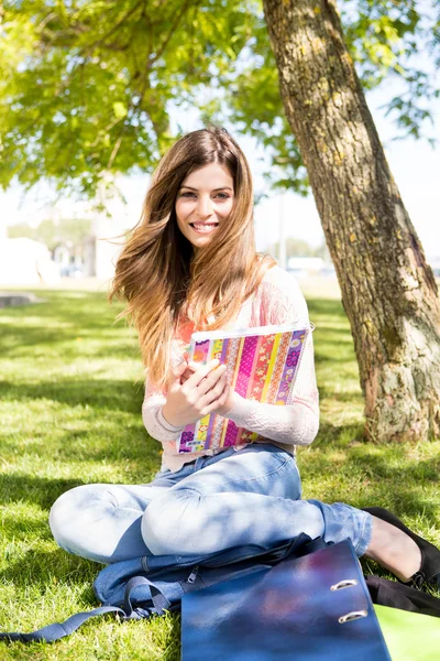 Estudiante joven estudiando en el jardín de la escuela — Foto de Stock