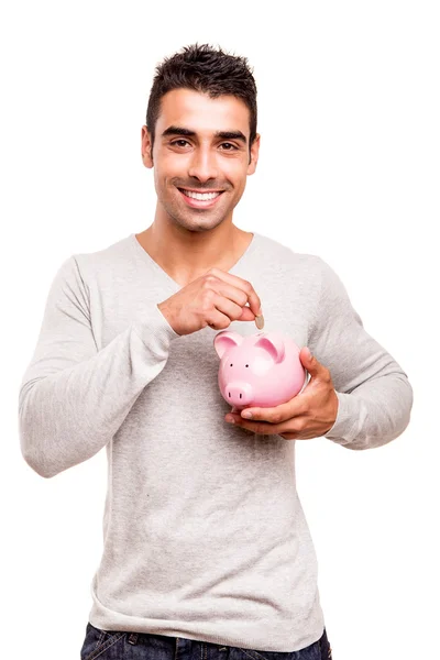 Mann spart Geld in Sparschwein — Stockfoto