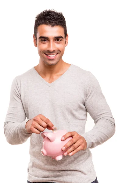 Man saving money to a piggy bank — Stock Photo, Image