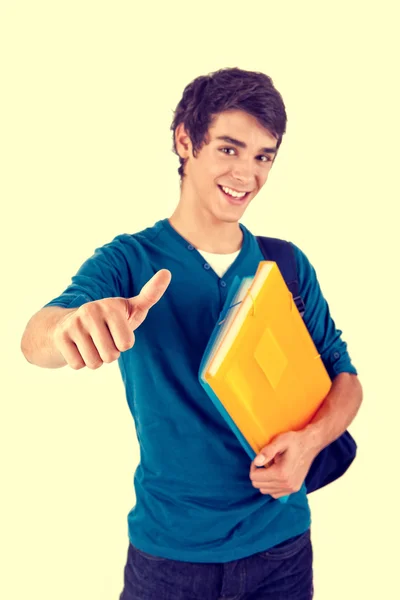 Mladý šťastný student ukazuje palec — Stock fotografie