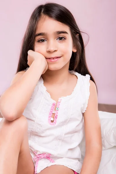 Little girl woke up in white bed — Stock Photo, Image