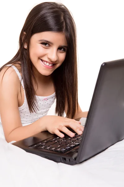 Girl with laptop on bed — Stock Photo, Image