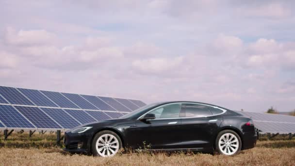 Na central de energia de painéis solares captura de vídeo de baterias fotovoltaicas e carro elétrico ecológico — Vídeo de Stock