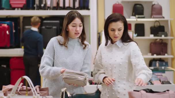 Twee charismatische dames een klant en een andere zijn supervisor van de winkel proberen een goed cadeau te vinden voor een speciaal persoon — Stockvideo