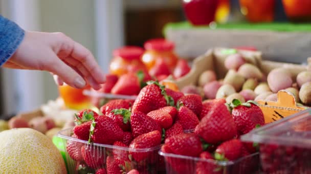 Στο κατάστημα τροφίμων πελάτης πάρει κάποια φρέσκα κόκκινη φράουλα από την έννοια κουτί των οικολογικών τροφίμων και φρέσκια συγκομιδή — Αρχείο Βίντεο