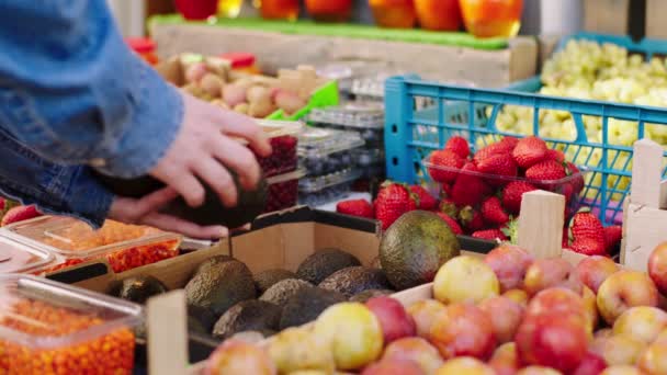 Concetto di industria agricola nel negozio di verdure biologiche commessa mettere alcuni avocado nella scatola di legno — Video Stock