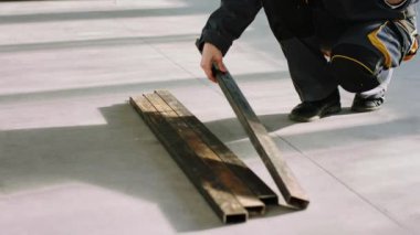 Construction site closeup to the camera engineer woman using digital tablet to order some building materials from online shop she wearing protective equipment and helmet