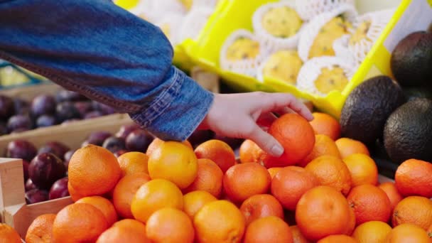 В овощном эко-магазине покупатель покупает свежие апельсины из коробочной концепции сельского хозяйства и свежего урожая. 4k — стоковое видео