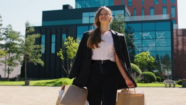 Izgatott gyönyörű hölgy előtt a kamera sétál az utcán néhány öko bevásárló táskák, és élvezze a pillanatot, miután egy jó vásárlási nap — Stock videók
