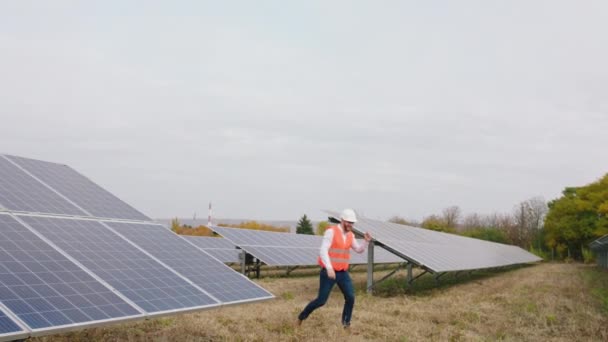 A kamera előtt izgatott a nagy mosoly ökológiai mérnök elkezd táncolni, miután véget ért, hogy ellenőrizze a fotovoltaikus akkumulátorok koncepciója zöld energia innováció — Stock videók
