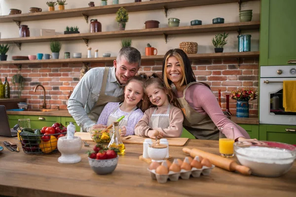 Portrait of cute family cooking together in kitchen — Stock Photo, Image