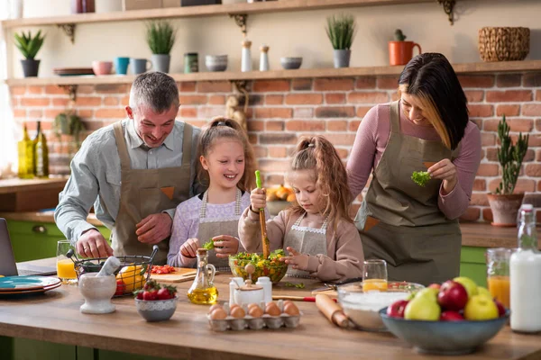 In front of the camera excited young and happy Caucasian family play Rock Paper Scissors before start to take the healthy breakfast all together — Stock Photo, Image