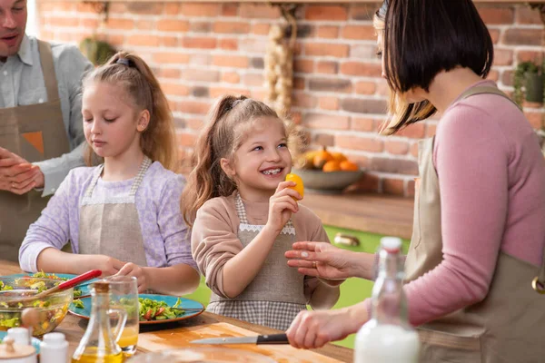 In a large spacious kitchen happy Caucasian family very excited taking breakfast together they smiling large feeling happy in front of the camera — Stock Photo, Image