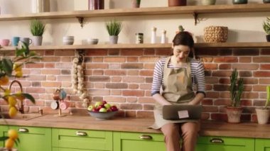Happy morning for a perfect looking woman and man they drink the tea together at the kitchen island enjoy the breakfast they smiling large and enjoy the time together