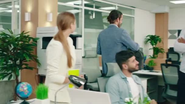 一个身穿蓝色西服的英俊男子走进一间办公室 愉快地和所有与会者打招呼 挥挥手高举双手 Arri Alexa Mini — 图库视频影像