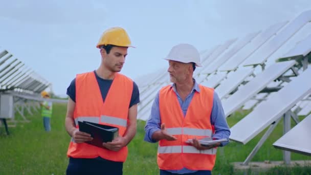 Walking Front Camera Two Charismatic Men Workers Examining Solar Batteries — Video Stock