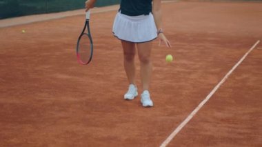 In the summer day outside of the tennis court professional player woman hits the ball professional with the racket concept of healthy lifestyle and sport. 4k
