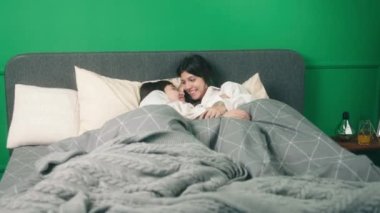 Amazing lesbian couple very beautiful ladies enjoy the morning together in bed they touching slowly each other and looking through eyes. 4k