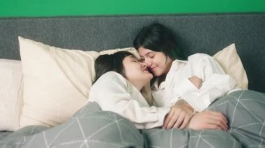 Concept of LGBT equality freedom friendship in the bedroom lesbian couple very in love kissing each other and touching with love. 4k