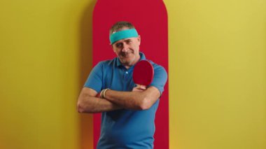 Posing in front of the camera charismatic old man all equipment he get ready to start playing on the ping pong game. 4k